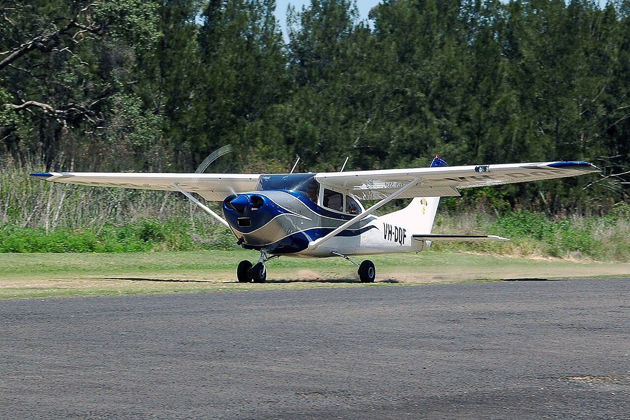 Small aircraft flying over Tennessee landscape